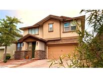 Charming two-story home with stone accents and a brick driveway at 5627 Spanish Valor Rd, Las Vegas, NV 89135