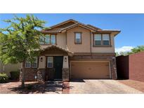 Charming two-story home with a two-car garage and landscaped front yard at 5627 Spanish Valor Rd, Las Vegas, NV 89135