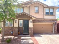 Charming two-story home boasts a beautifully designed exterior and a well-maintained front yard at 5627 Spanish Valor Rd, Las Vegas, NV 89135