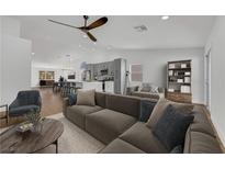 Bright open-concept living room and kitchen featuring modern finishes, stainless steel appliances, and a spacious island at 6664 Rutgers Dr, Las Vegas, NV 89156