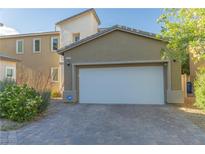 Charming home featuring a spacious two-car garage with a paved driveway and well-maintained landscaping at 7175 Steubling Glen St, North Las Vegas, NV 89084