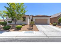 Charming single-story home featuring a tile roof, neutral stucco, and a manicured, low-maintenance front yard at 8232 Silver Vine St, North Las Vegas, NV 89085