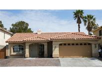 Charming single-story home with tile roof, desert landscaping, and attached two-car garage at 8504 W Gilmore Ave, Las Vegas, NV 89129