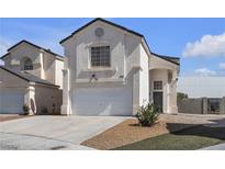 Charming home with a two-car garage and stucco exterior, complemented by a well-manicured lawn at 9290 S Cool Creek Ave, Las Vegas, NV 89147