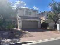 Charming two-story home with a brick driveway and a neutral color scheme, offering curb appeal at 11021 Pentland Downs St, Las Vegas, NV 89141