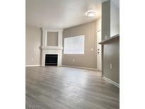Bright living room with fireplace and large window, providing ample natural light at 1881 W Alexander Rd # 1128, North Las Vegas, NV 89032