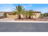 Inviting single-story home featuring a tile roof, desert landscaping and a two-car garage at 2318 Shorewood Hills Ave, Henderson, NV 89052