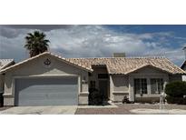 Charming single-story home with a well-manicured front yard and a two-car garage and neutral color scheme at 4382 Valley Regal Way, North Las Vegas, NV 89032