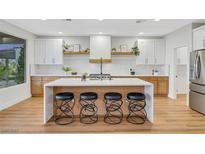 Bright kitchen features modern appliances, a large island with seating, and stylish countertops at 4718 Atlantico St, Las Vegas, NV 89135