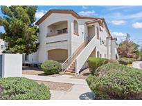 Well-maintained condominium with lush landscaping, covered entry, and private balcony, showcasing inviting curb appeal at 5655 E Sahara Ave # 2044, Las Vegas, NV 89142