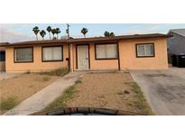 Single story home with a low-maintenance front yard and a long driveway at 621 Van Ert Ave, North Las Vegas, NV 89030