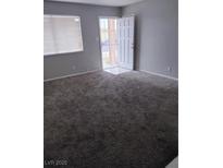 Spacious living room featuring carpet and a front door at 621 Van Ert Ave, North Las Vegas, NV 89030