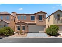 Inviting two-story home displaying a terracotta roof, two-car garage, and warm stucco exterior at 8059 Wards Ferry St, Las Vegas, NV 89139