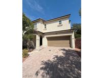 A charming two-story home with a two car garage and a brick driveway at 1030 Maple Pines Ave, North Las Vegas, NV 89081