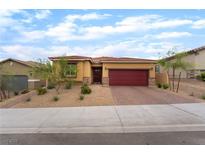 Single story home featuring a red tile roof, a brick driveway, and desert landscaping in the front yard at 10943 Artisan Ranch Ave, Las Vegas, NV 89166