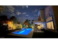 Inviting backyard pool with stylish lounge area, perfect for evening relaxation and enjoyment at 1701 Tesara Vista Pl, Las Vegas, NV 89128