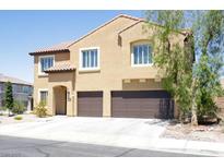 Two-story stucco home boasts a tile roof, two-car garage, and well-maintained landscaping at 176 Jay Porter Ave, Henderson, NV 89002