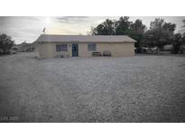 Charming single-story home with neutral stucco exterior and spacious gravel front yard at 1930 N Murphy St, Pahrump, NV 89060