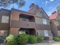 Condo exterior featuring a stucco facade, tiled roof, and well-maintained landscaping at 2200 S Fort Apache Rd # 2113, Las Vegas, NV 89117