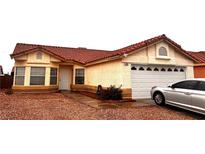 Charming single-story home featuring a terracotta roof, two-car garage, and low maintenance desert landscaping at 2595 Fort Lauderdale Dr, Las Vegas, NV 89156