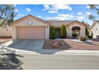 Charming single-story home featuring a two-car garage and well-maintained landscaping in a peaceful neighborhood at 2605 Lotus Hill Dr, Las Vegas, NV 89134