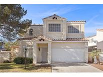 Charming two-story home with a well-manicured front yard and attached two-car garage at 3425 Creek River Dr, Las Vegas, NV 89129