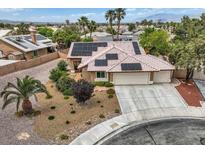 Inviting home featuring a two-car garage, desert landscaping, and solar panels for energy efficiency at 3619 Bixbee Ct, Las Vegas, NV 89129