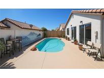 Inviting backyard pool with desert landscape and mountain mural on privacy wall at 3808 Lilac Haze St, Las Vegas, NV 89147