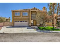 Inviting two-story home showcasing a well-manicured lawn and a spacious driveway leading to an attached garage at 4 Bishopsgate Ter, Henderson, NV 89074