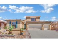 Charming two-story home with a three-car garage, desert landscaping and blue sky backdrop at 4330 Oasis Hill Ave, North Las Vegas, NV 89085