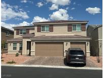 Inviting two-story home with a three-car garage and well-maintained landscaping at 5404 Scandia Lore Ct, Las Vegas, NV 89130
