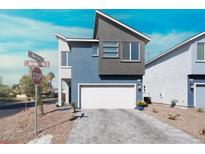Modern two-story home boasts a two-car garage, contemporary design and desert landscaping at 63 Harrison Rose Ct, Las Vegas, NV 89110
