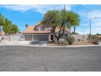Charming two-story home features a three car garage and a well-maintained, landscaped front yard at 6700 Pine Needle Ct, Las Vegas, NV 89108