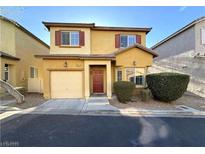 Two-story home featuring an attached garage, well-maintained landscaping, and warm curb appeal at 6777 Wormwood Ln, Las Vegas, NV 89148
