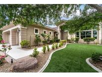 Charming single-story home featuring a lush, well-manicured front yard and inviting curb appeal at 801 Aquitaine Ct, Las Vegas, NV 89145