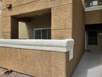 A modern building with private covered patio featuring textured stucco and bright, neutral color palette at 8070 W Russell Rd # 1028, Las Vegas, NV 89113