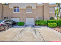 Charming townhome featuring two-car garage and well-maintained landscaping at 915 Graceful Moon Ave, Henderson, NV 89015