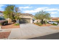 Charming single-story home featuring a desert landscape, a two-car garage, and a concrete driveway at 925 Crescent Falls St, Henderson, NV 89011