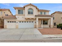 Charming two-story home featuring a three-car garage, landscaped front yard, and a classic desert color palette at 9630 Tuscola Ct, Las Vegas, NV 89148