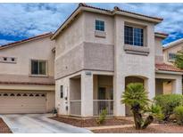 Charming two-story home boasts a desert landscape, covered porch, and attached two car garage at 1115 Aldenwood Ave, Las Vegas, NV 89123