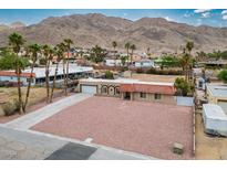 Spacious single-story home featuring a desert landscape, mountain views, and a private driveway at 138 Palma Del Rio, Las Vegas, NV 89110