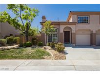 Charming townhome featuring desert landscaping, a private garage, and a welcoming entrance at 1617 Cave Spring Dr, Henderson, NV 89014