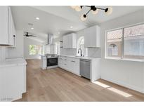 Bright kitchen with white cabinets, stainless steel appliances, and quartz countertops at 1705 Imperial Cup Dr, Las Vegas, NV 89117
