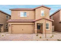 Two-story home featuring a two-car garage, red tile roof, and low maintenance desert landscaping at 1720 Sandia Rock Ave, North Las Vegas, NV 89032