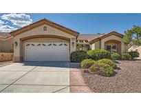 Charming single-story home featuring a two-car garage, desert landscaping, and a welcoming front entrance at 2601 Deer Lake St, Las Vegas, NV 89134
