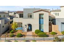 Charming two-story home with desert landscaping, black metal fence, and colorful blue accents at 2710 Marchetti Pl, Henderson, NV 89044