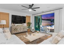 Bright living room with modern furnishings, open floor plan, and access to the outdoor patio and pool at 2710 Marchetti Pl, Henderson, NV 89044
