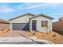 Charming single-story home with a gray facade, complemented by a two-car garage and neat landscaping at 2733 Avril Point St, Las Vegas, NV 89156