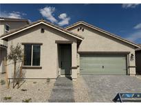 Charming single-story home with a two-car garage, desert landscaping, and a welcoming entryway at 3240 Lahontan St, North Las Vegas, NV 89032