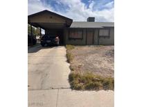 Modest single-story home featuring a covered carport and drought tolerant landscaping at 3933 Lighthouse Ave, Las Vegas, NV 89110